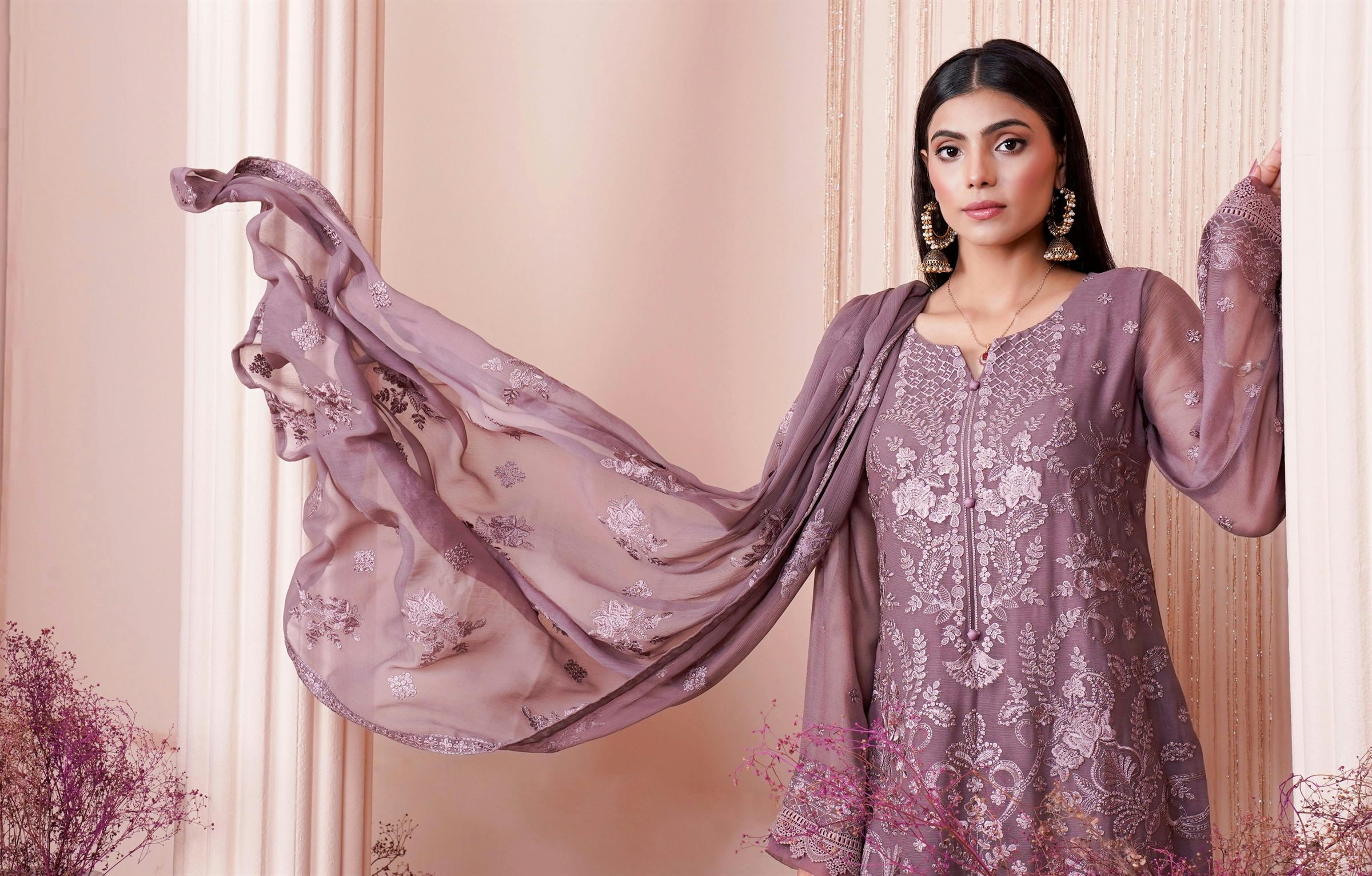 Noor-e-Prit — a woman in a mauve embroidered kurta set with a flowing dupatta